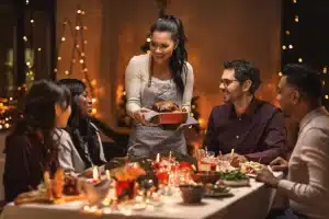 Someone serving Christmas dinner to friends
