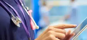 Nurse filling in a form on a tablet