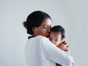Woman kissing baby