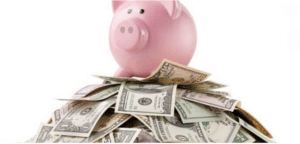Piggy bank on top of lots of dollar notes