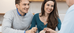 Happy couple talking to doctor