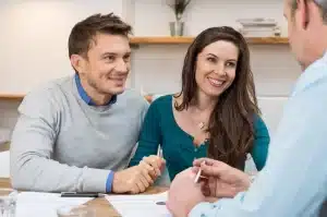 happy couple talking to doctor