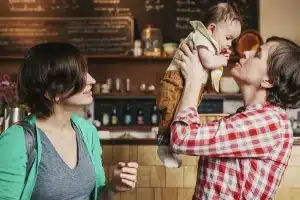 Two women with baby in coffee shop
