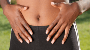 Woman holding flat tummy