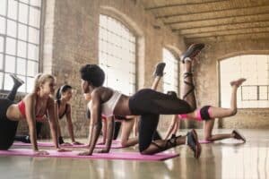 Woman performing yoga together