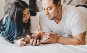 Man and female couple holding baby together
