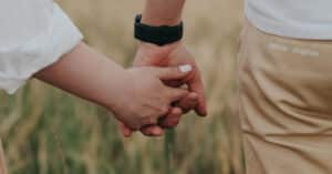 Zoomed in holding hands